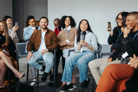 Dynamic young marketing professionals engaged in a spirited discussion at a New York networking event