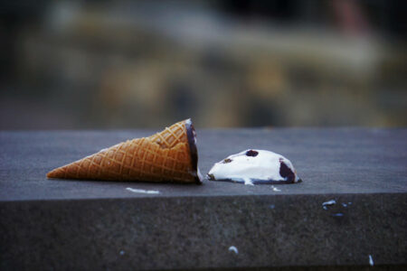 An ice cream cone with the ice cream fallen to the ground, symbolizing a mistake in digital marketing