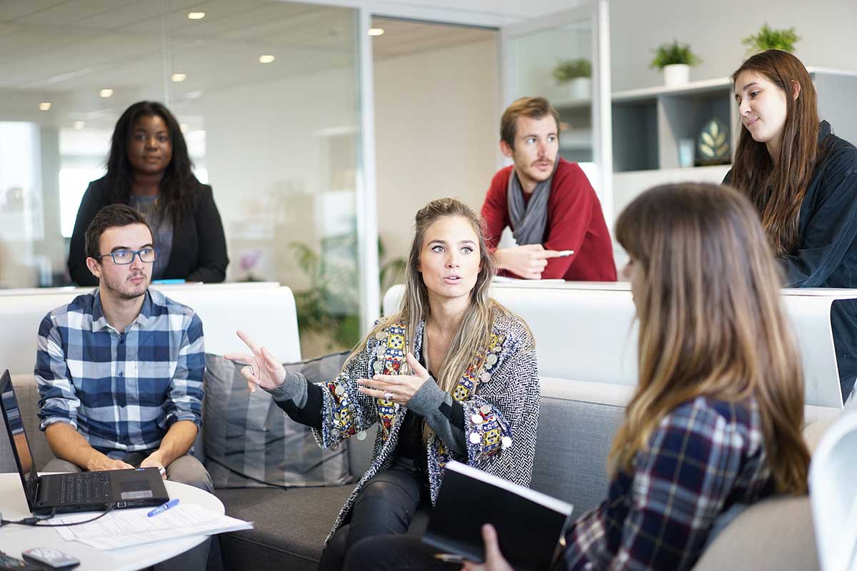 a team of digital marketers engaged in a project discussion during a meeting in a modern office, analyzing data and strategizing together