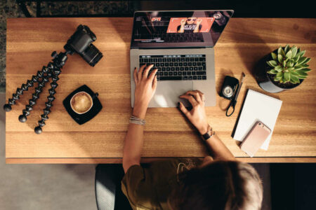 Marketer editing photos for social media on a MacBook